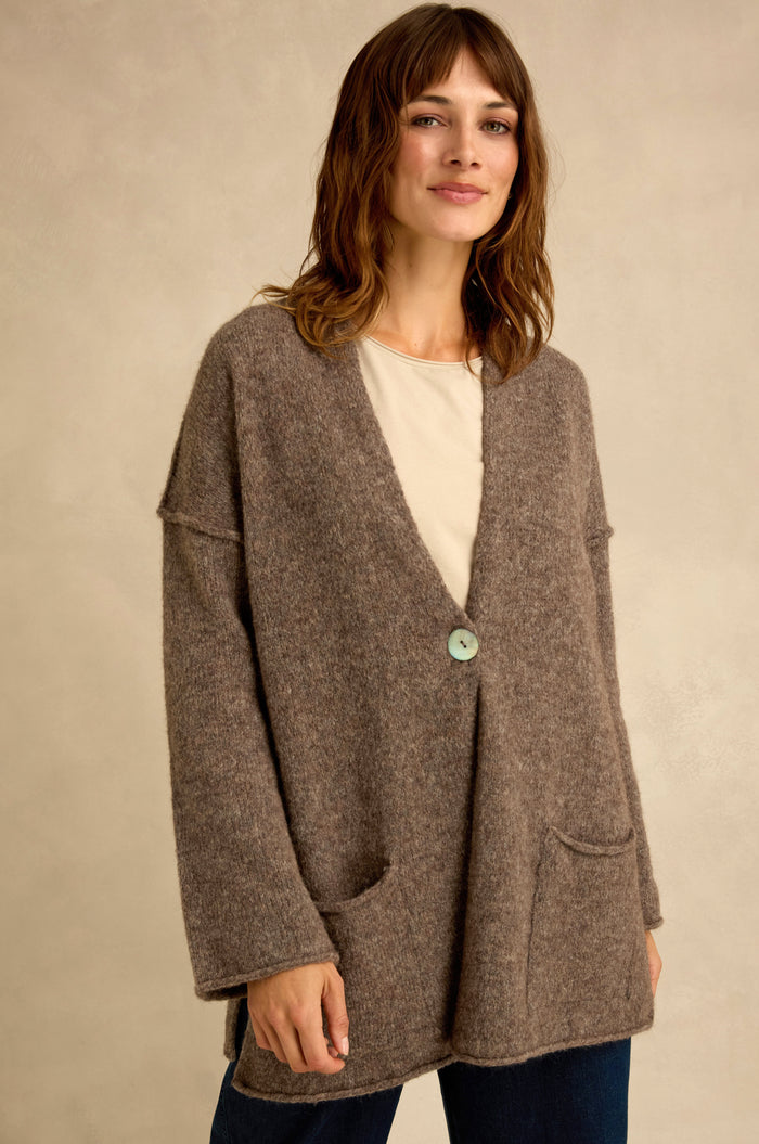A woman wearing the Bark Alpaca Blend Long Line Cardigan with front pockets over a light shirt, standing against a neutral background.