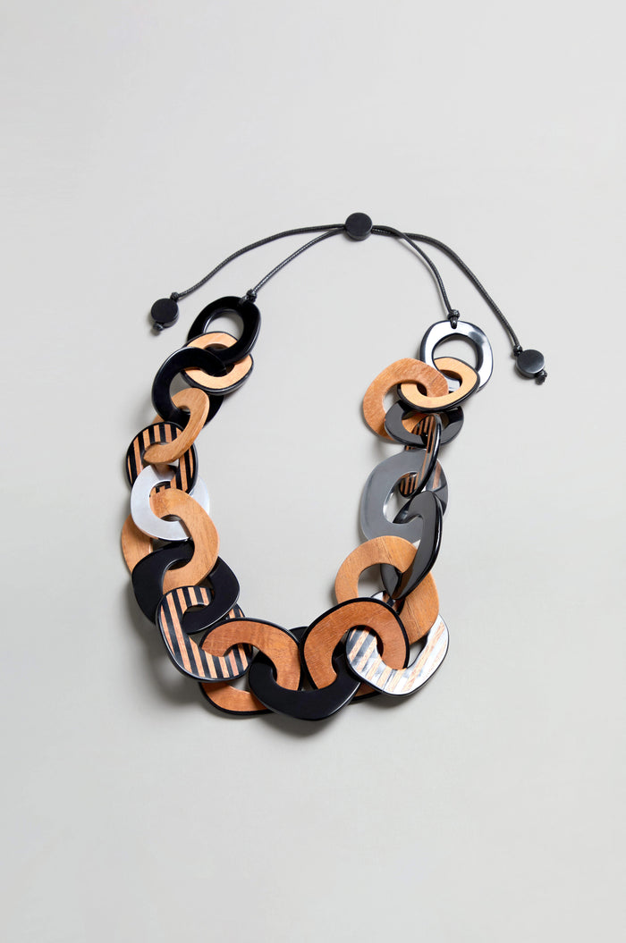Introducing the Black Stripe Wooden Resin Links Necklace—a bold statement collar featuring oversized interlocking resin and wood links in black, brown, and gray tones, finished with a black adjustable cord and sliding knots.