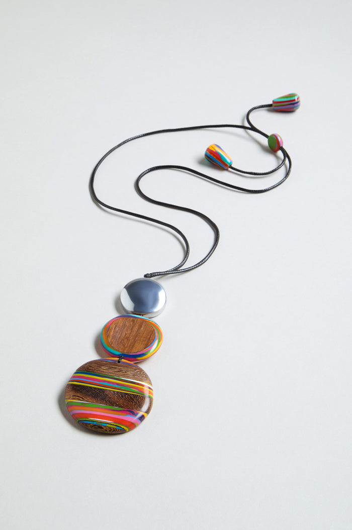 The Colourburst Triple Sphere Necklace features a long black multicolour resin chain with two vibrant round pendants and a silver sphere, plus matching handmade beads at each end, shown against a plain light background.