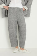 A person wears the Crinkle Double Face Linen Bubble Trouser in gray with a relaxed bubble fit, paired with a matching gray jacket, white top, and white sneakers, standing against a plain white background.