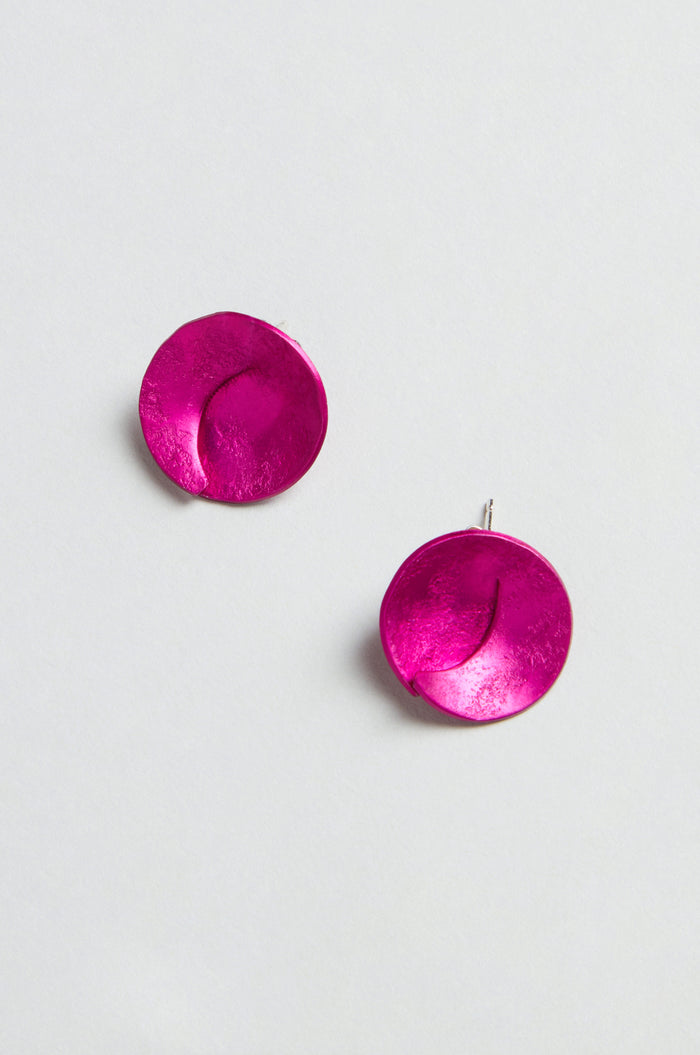 Curved Disc Earrings: round, textured metallic pink anodised aluminium with sterling silver posts, shown on a plain light background.