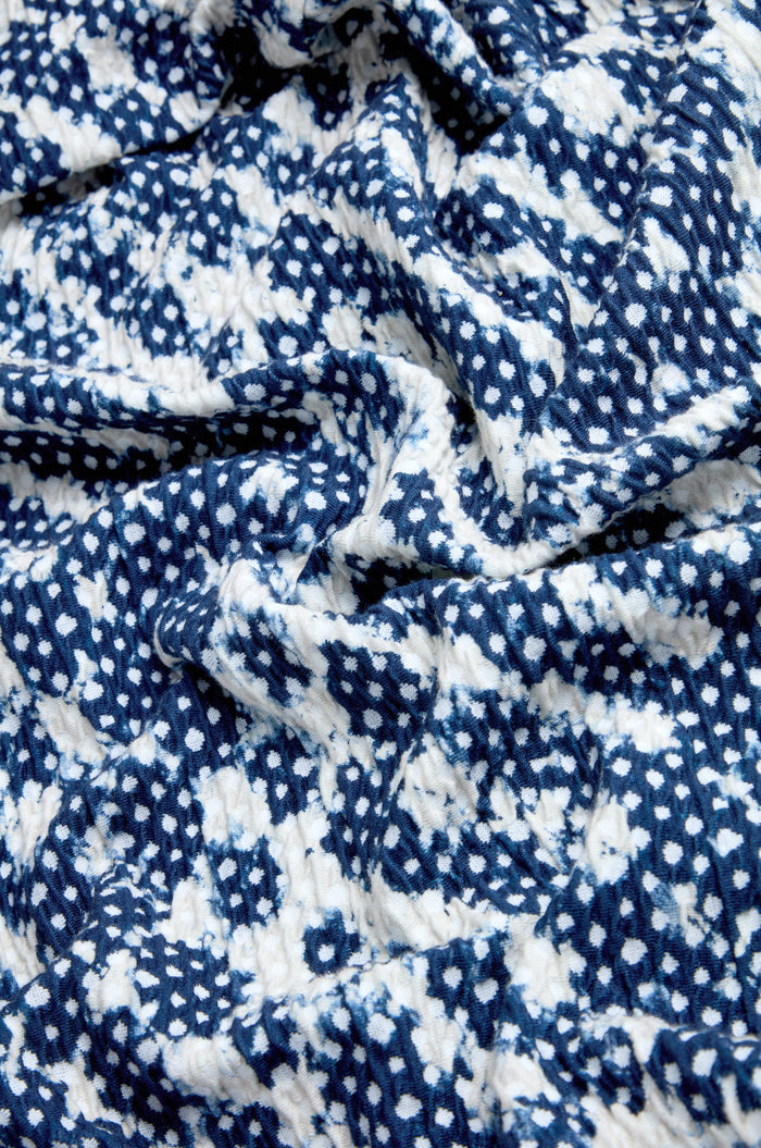 Blue and white Diamond Tie Dye Jersey Jacket made in England, featuring a textured, crumpled surface with an abstract dotted design.
