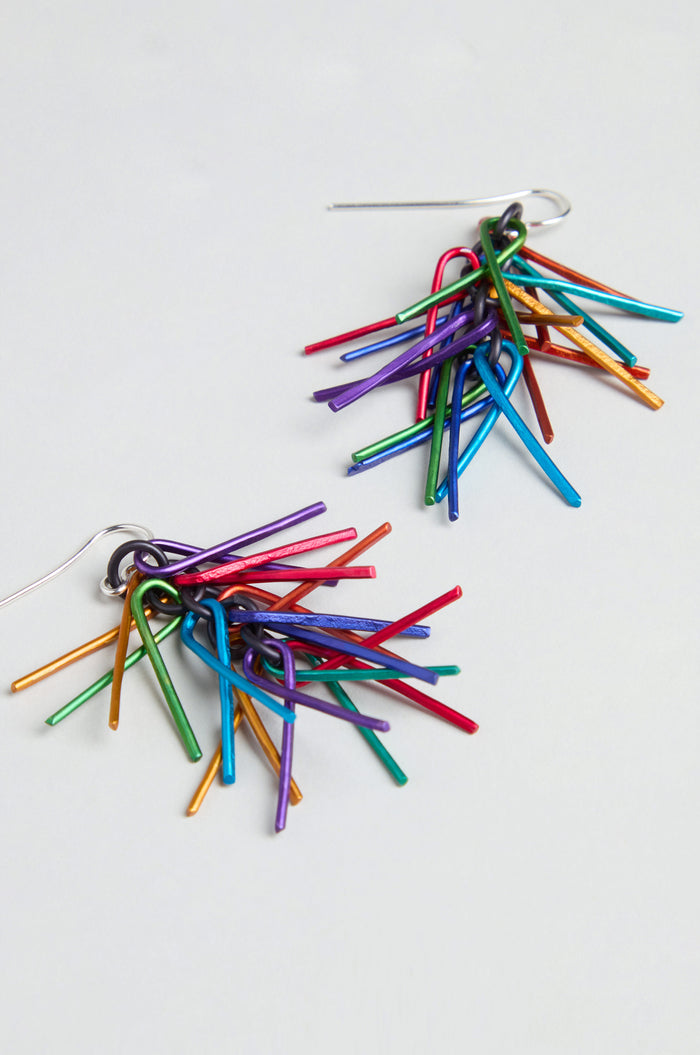 Fringe Earrings featuring colorful anodized aluminum sticks clustered together with sterling silver hooks, displayed on a light background.