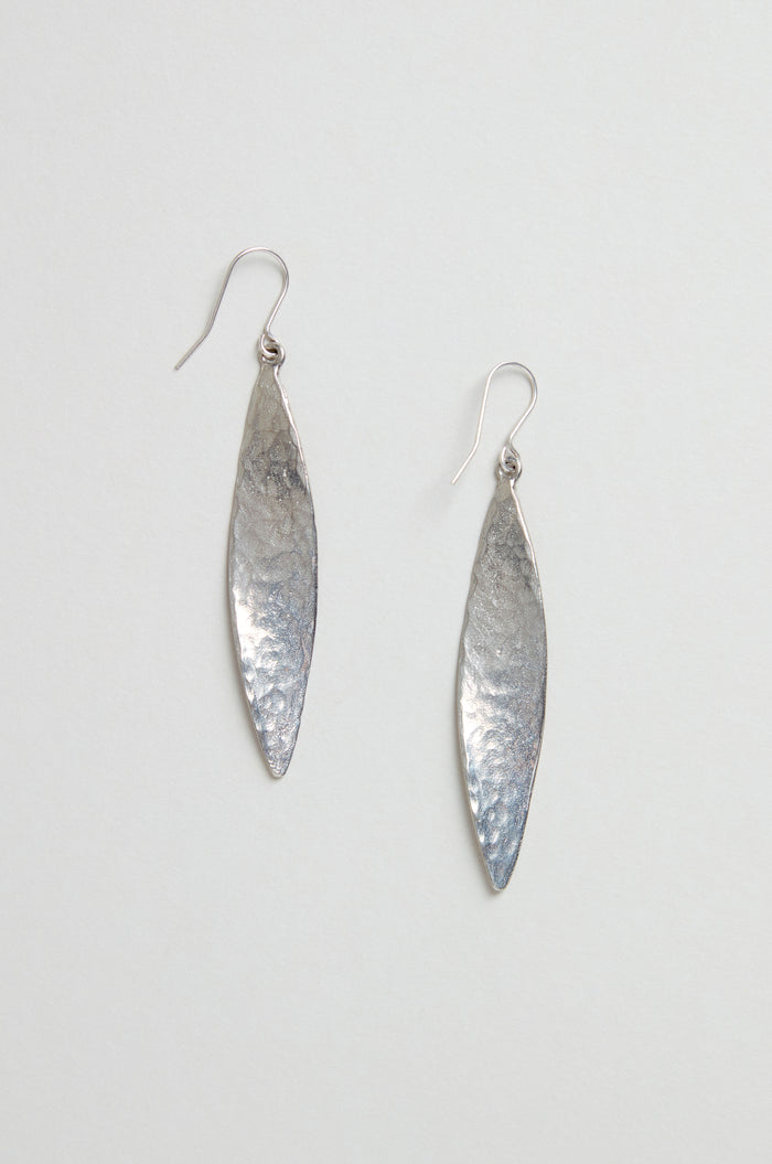 Hammered Silver Leaf Earrings—long, leaf-shaped silver earrings with a textured, hammered finish—shown against a plain light background.