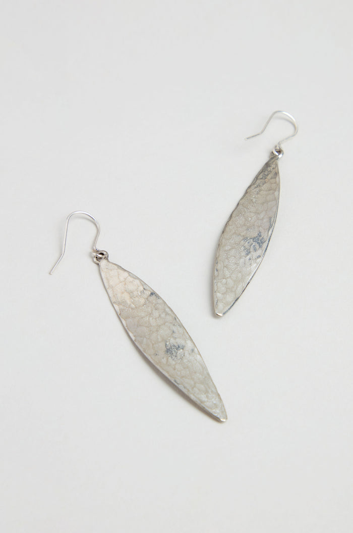 Hammered Silver Leaf Earrings with a textured finish dangle elegantly in a leaf-shaped design against a plain white background.