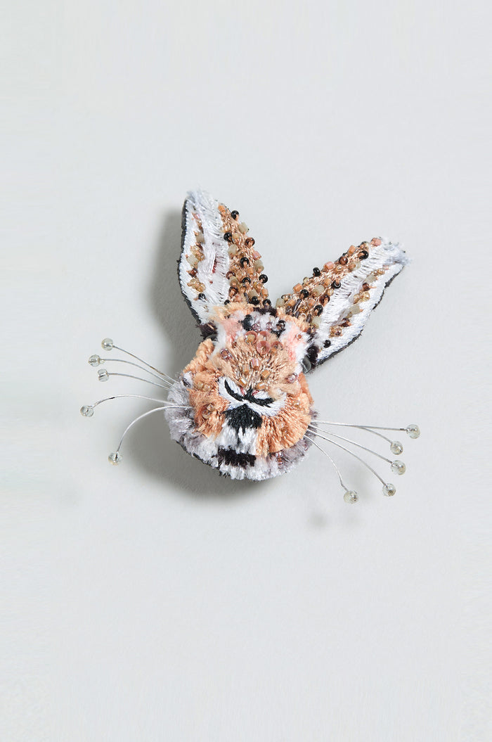 The Hand Embroidered Bunny Rabbit Brooch features a small animal head with long ears, intricate beadwork, and wire whiskers tipped with beads, presented on a plain background.