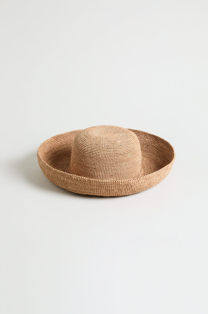 Handwoven Raffia Tie Hat with a rounded crown and wide, flat brim, displayed on a plain white background.
