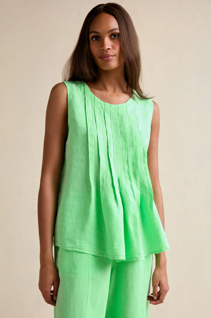 Woman wearing the Linen Pleat Front Pistachio Vest with matching pants, standing against a neutral background.
