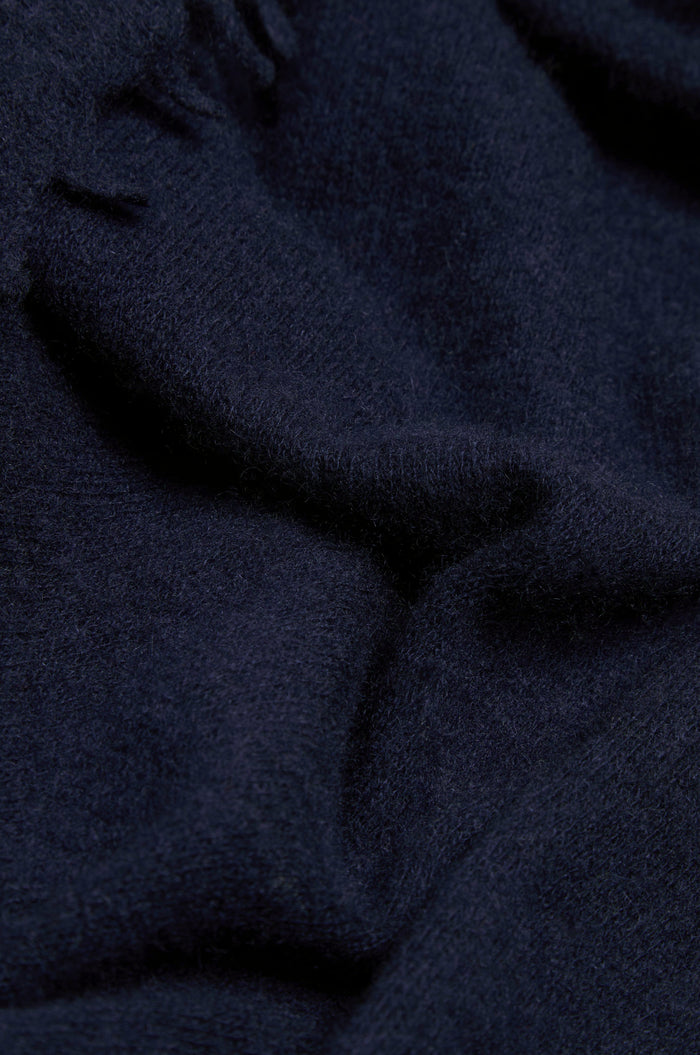 Close-up of the Navy Soft Cashmere Scarf, featuring dark blue wool or fleece fabric with a soft texture and gentle folds.