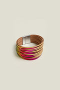 The Woven Metallic Bracelet is a colorful multi-strand twisted leatherette accessory with a magnetic clasp, featuring shades of beige, pink, and yellow against a plain background.