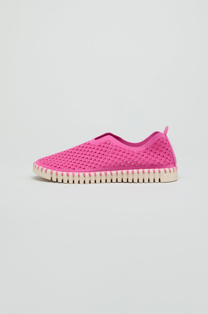 A single Rose Tulip Slip on Shoe, featuring a pink upper and white ridged sole, is showcased on a plain background, highlighting its lightweight comfort.