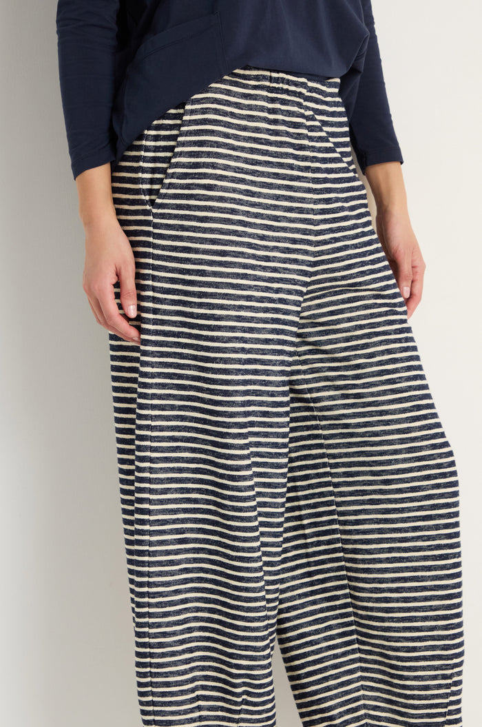 A person wears Textured Stripe Jersey Bubble Trousers with an elasticated waist and a navy long-sleeve top, standing against a plain background.