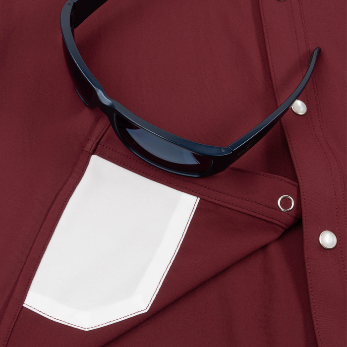 Closeup of sunglasses with lens cleaner on shirt