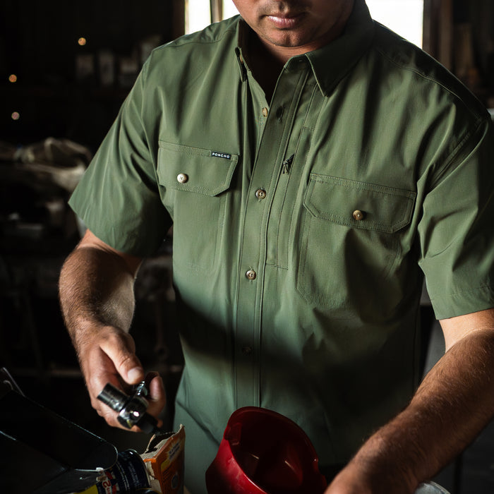 man with tool wearing green short sleeve tuff-thread shirt