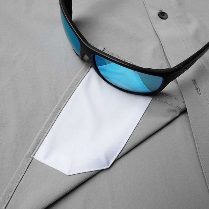 Closeup of sunglasses with lens cleaner on shirt