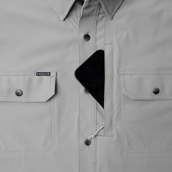 Phone in chest zipper pocket of shirt
