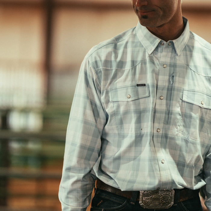 Man wearing The Billings plaid outdoor shirt with buttoned chest pockets and belt buckle