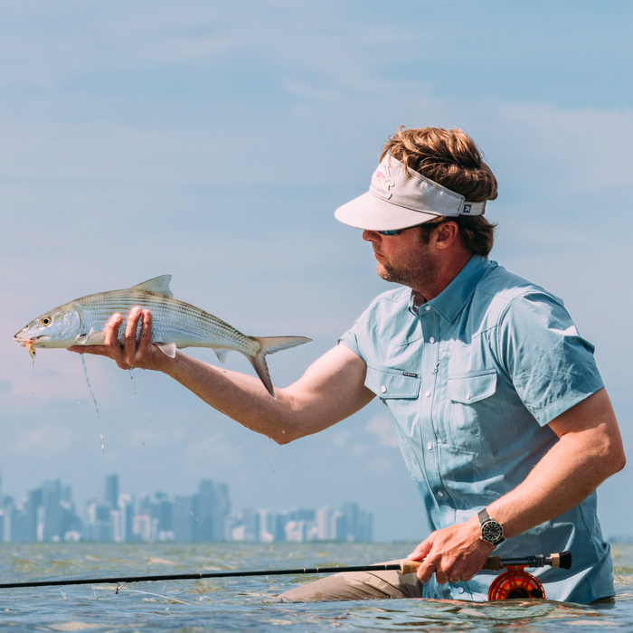 man holding fish wearing the biscayne shirt