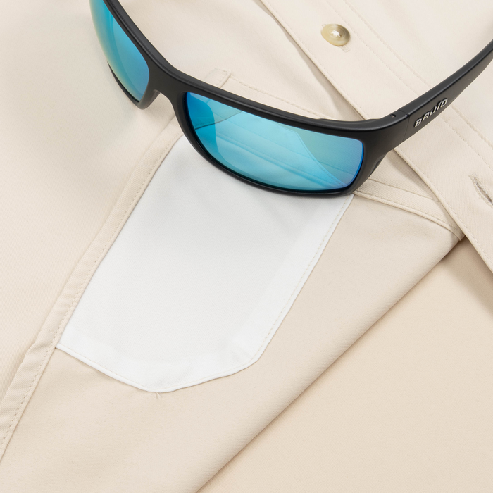 Closeup of sunglasses with lens cleaner on shirt
