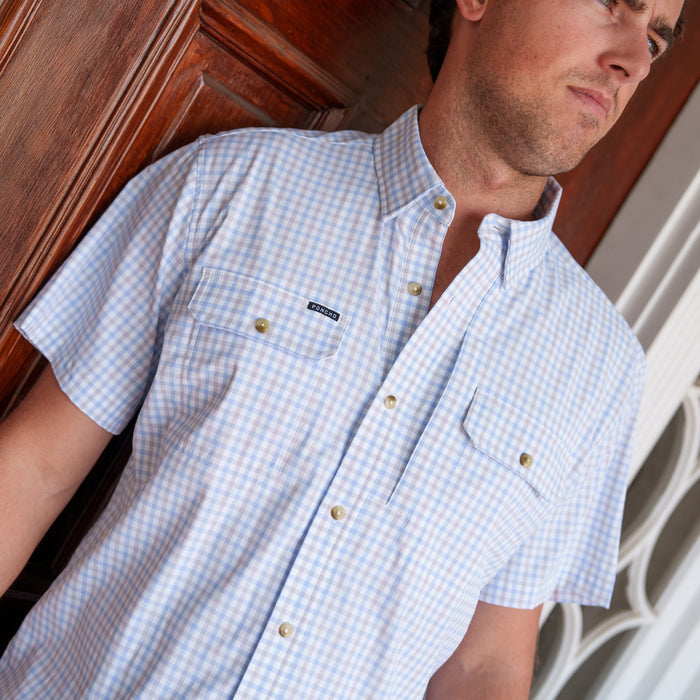 The Channel Cat blue and grey plaid men's fishing shirt with short sleeves, button-down collar, and dual chest pockets