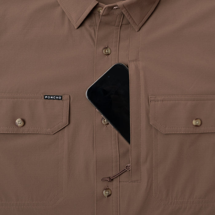 The Clark brown outdoor shirt with hidden chest pocket holding a smartphone