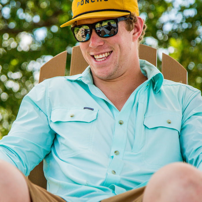 man smiling wearing light green shirt