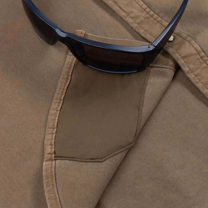 Close-up of a brown fabric pocket detail on The Cotulla shirt with black sunglasses resting on it.