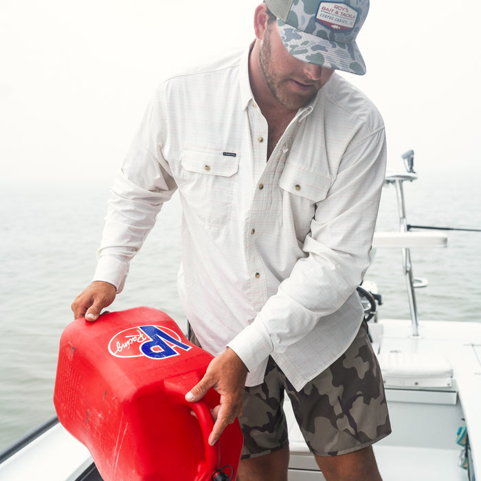 man filling boat up with gas in The Cumberland shirt
