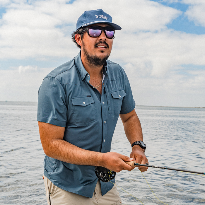 man fishing wearing the dogtooth shirt