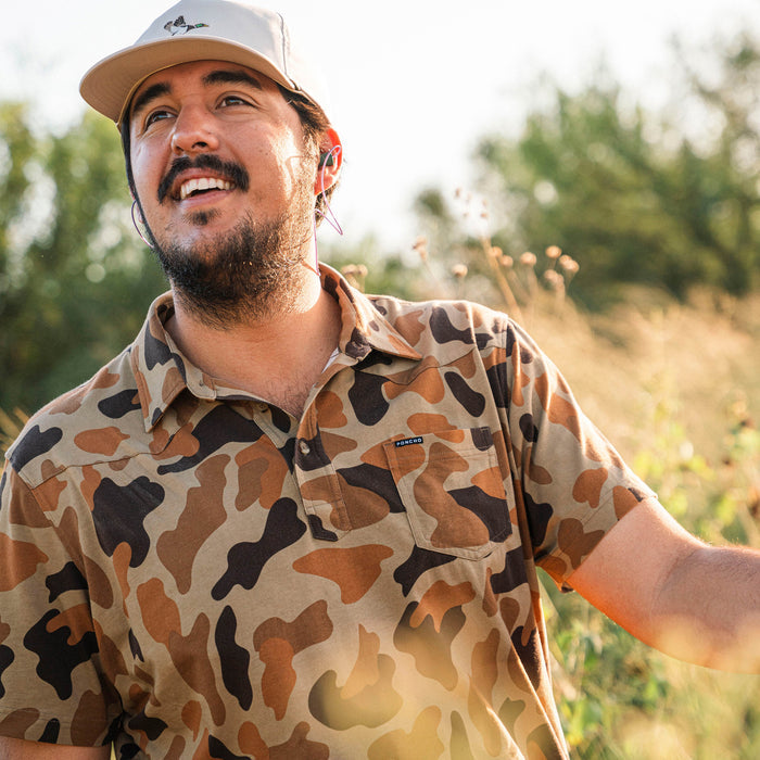 man wearing camo polo shirt
