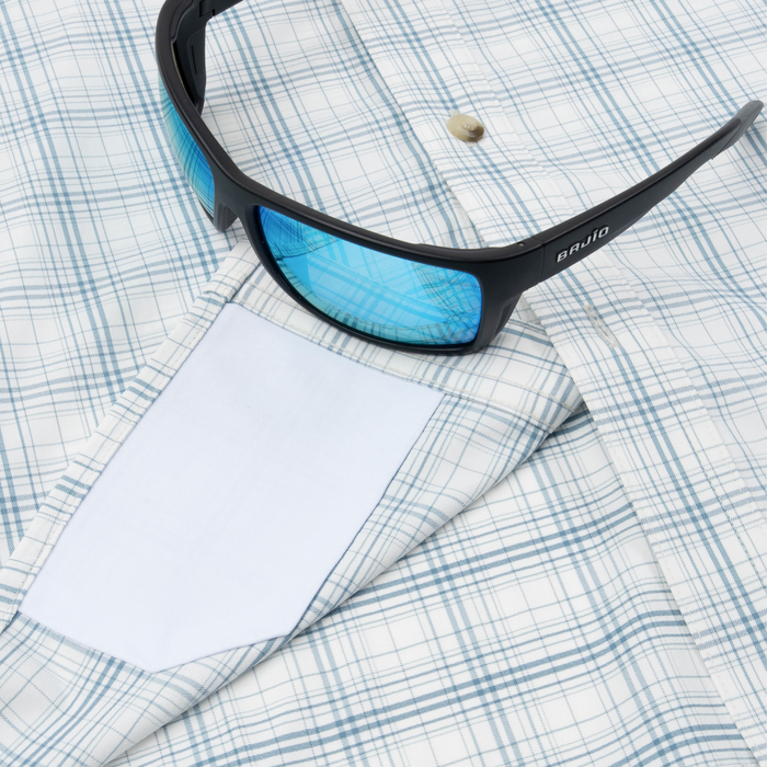 Closeup of sunglasses with lens cleaner on shirt