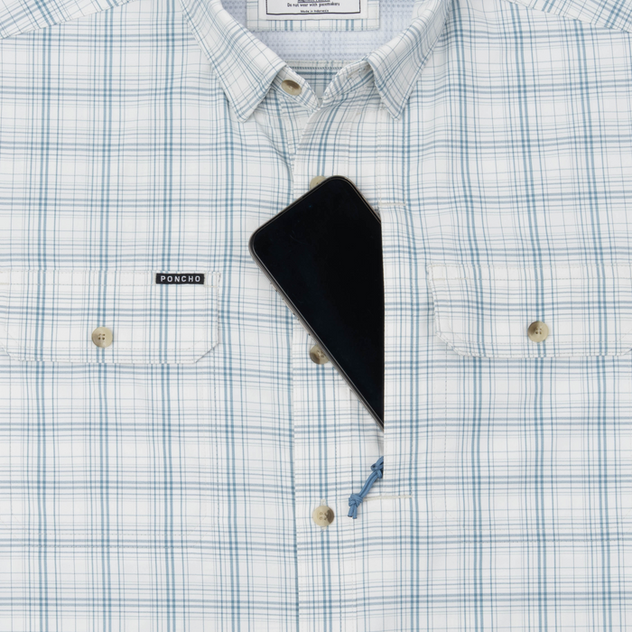 Phone in chest zipper pocket of shirt