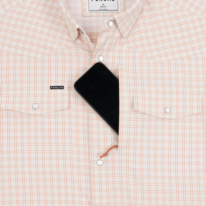 Phone in chest zipper pocket of shirt