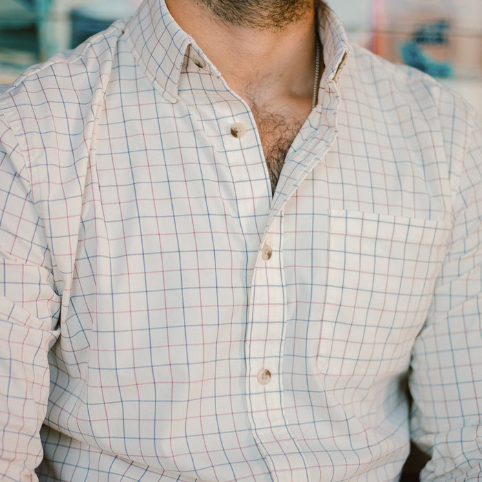 Close up of man wearing blue and red plaid button down shirt