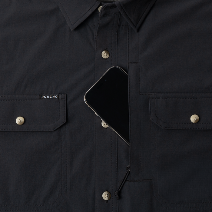 Phone in chest zipper pocket of shirt
