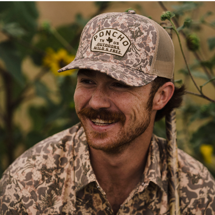 The Game Hat by Poncho Outdoors featuring a camouflage pattern and breathable mesh back
