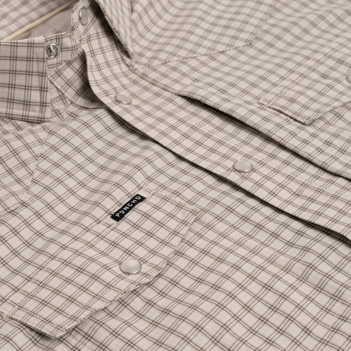 Close up photo of brown plaid pearl snap buttons