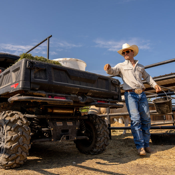 The Guthrie button up shirt worn outdoors beside a utility vehicle