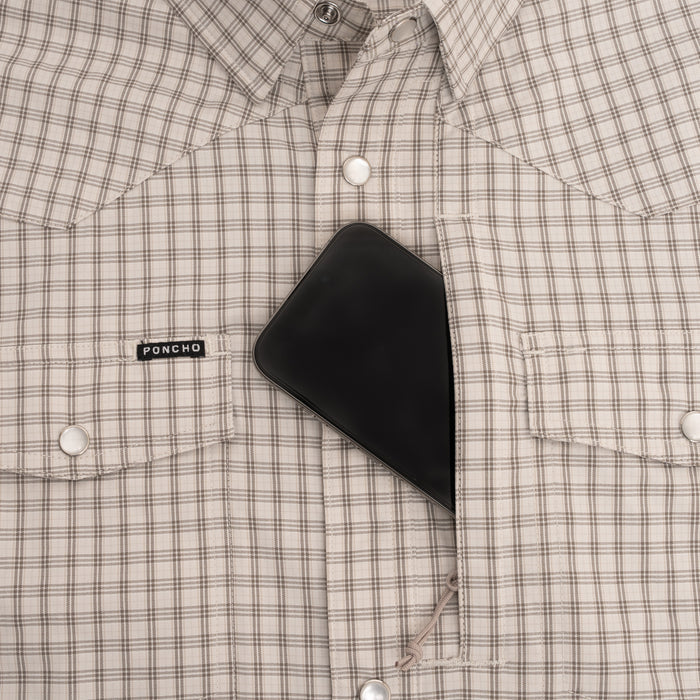 Phone in pocket of brown plaid pearl snap