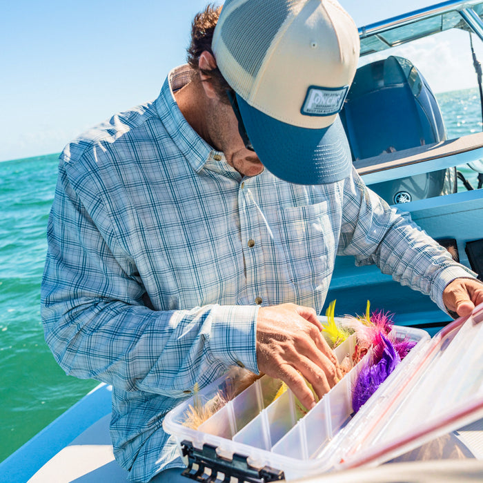 man with tackle box wearing the head shake shirt
