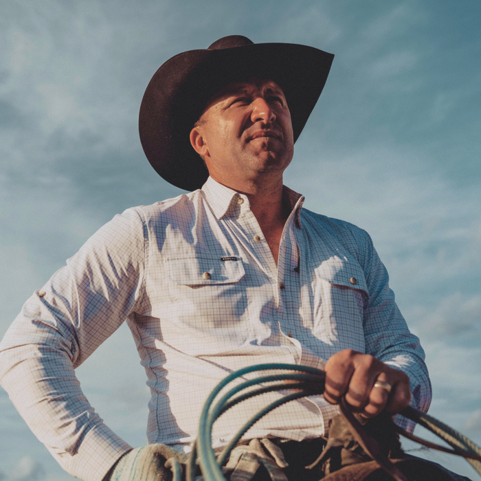 man on horse wearing the high bidder shirt