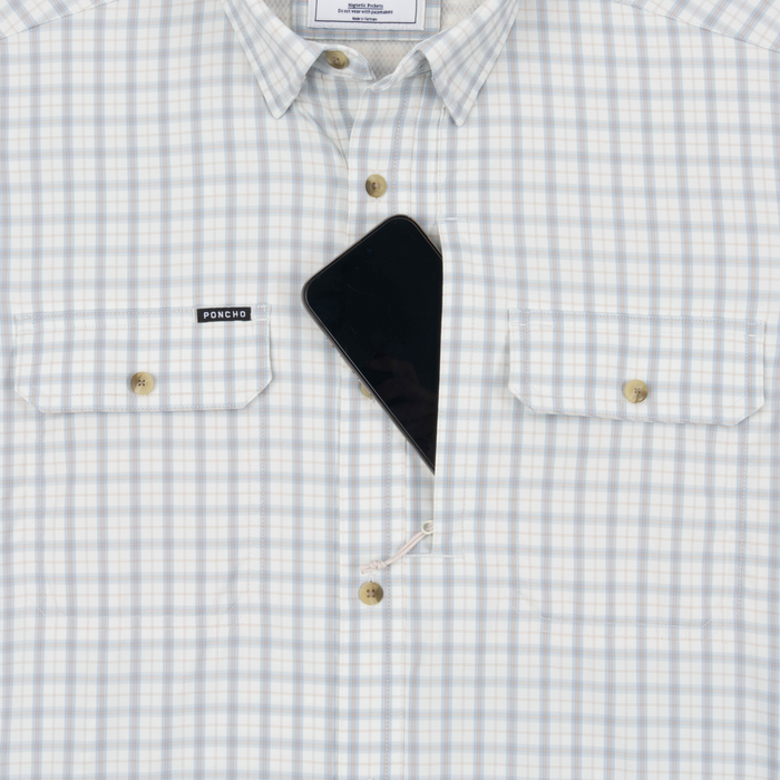 Phone in chest zipper pocket of shirt