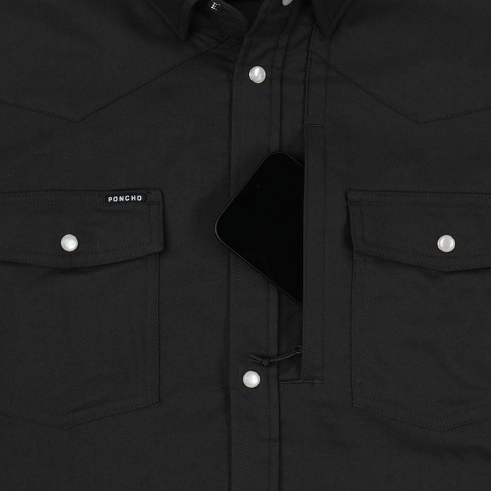 Close-up of black shirt pocket with phone and pearl buttons from The Laramie