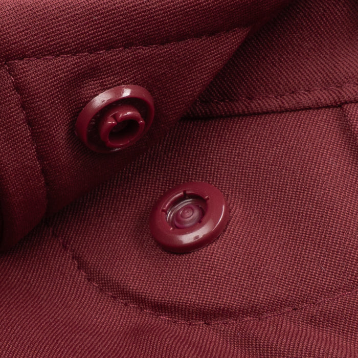 Close-up of a maroon button detail on The Man Coverage breathable outdoor shirt fabric