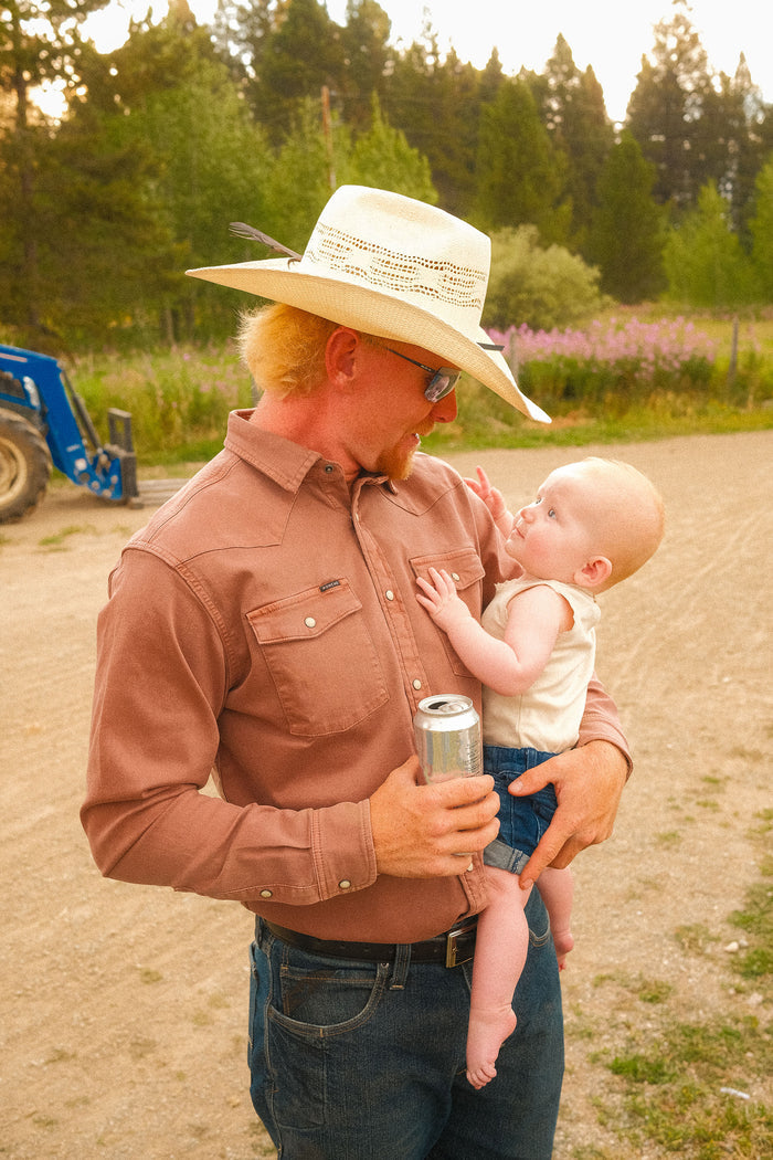 Man holding baby in red denim