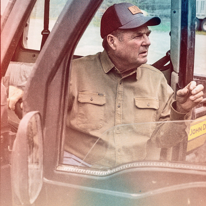 The Monteagle man wearing a tan button up shirt and cap inside a utility vehicle