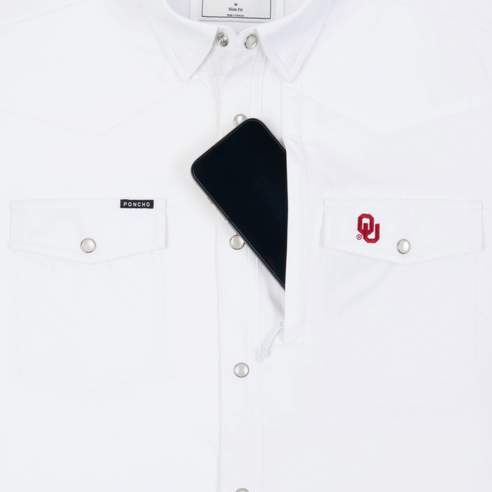 Phone in chest zipper pocket of shirt