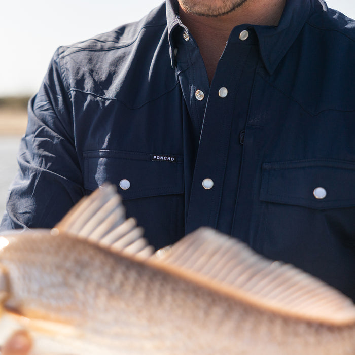 man holding fish wearing the pacifico shirt