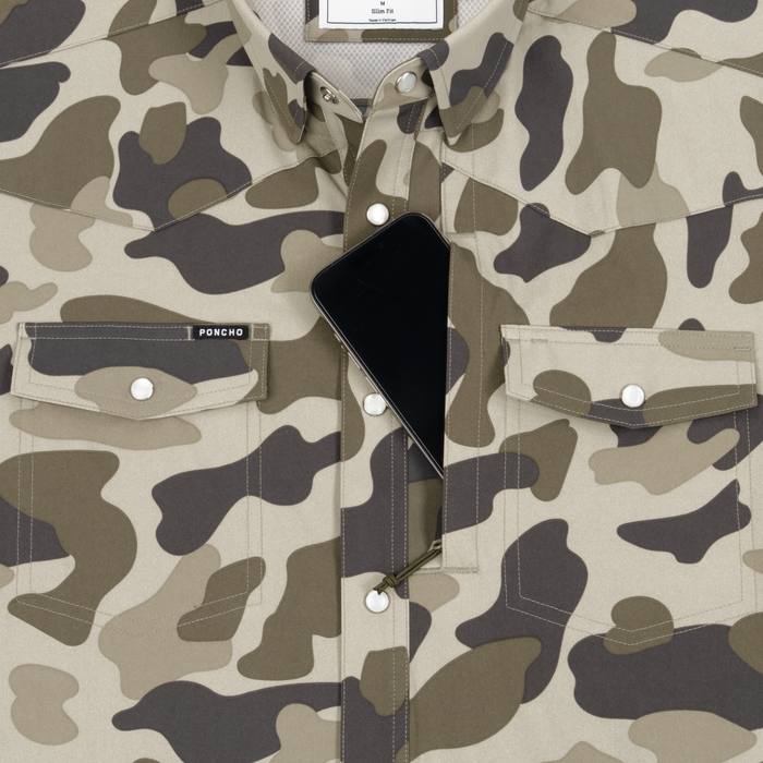 Close-up of The Pampa camouflage shirt with a hidden zippered pocket holding a smartphone