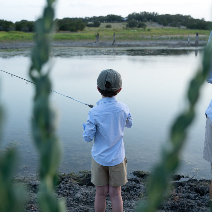 Kid fishing in blue microcheck kids shirt